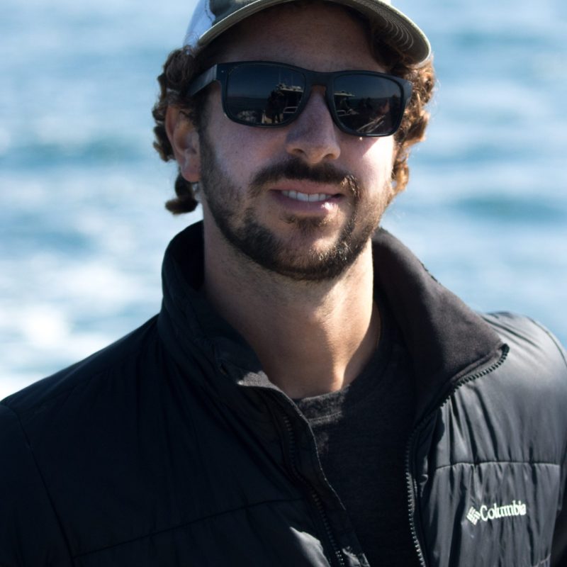 a man wearing a hat and sunglasses