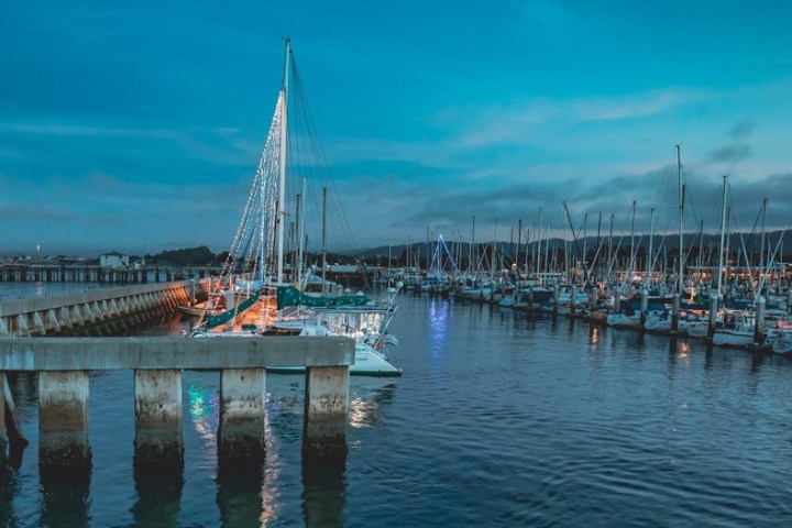 a boat is docked next to a body of water