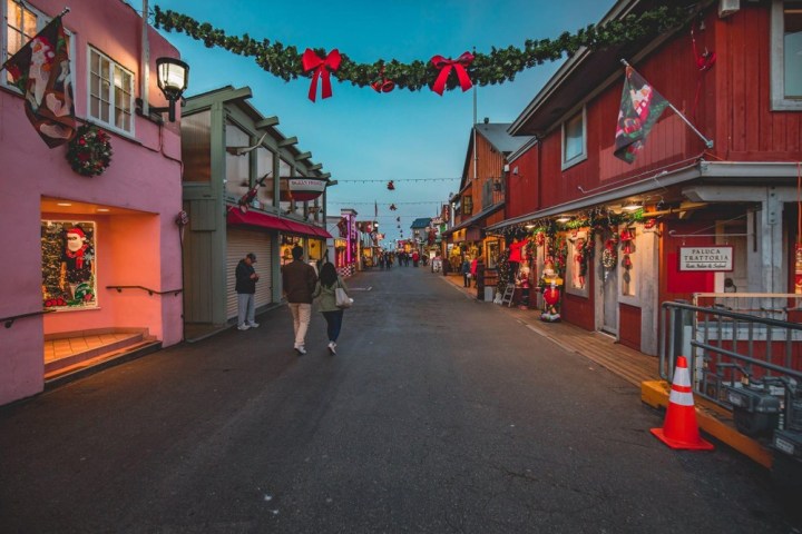 a person walking down a street next to a building
